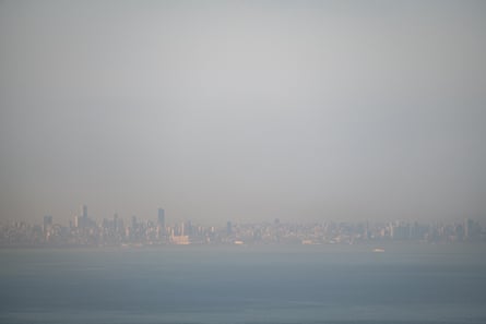 The Beirut skyline, just visible in the far distance amid a haze of smog caused by traffic and generators