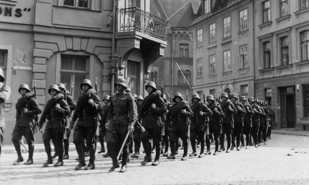 German soldiers marching through a town in Holland in May 1940.