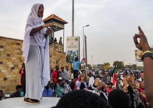 SUDAN-UNREST-DEMOAlla Salah stands on a vehicle as she sings to the crowd.