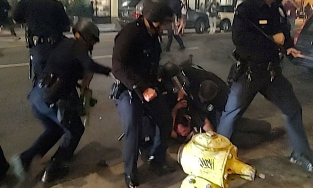 Police hold a pro-choice demonstrator to the ground in Los Angeles, California.