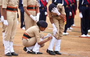 Security personnel adjust their uniform in Bangalore, India, during a full-dress rehearsal ahead of the 74th Republic Day celebrations