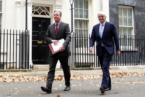 David Cameron, foreign secretary (left), and Andrew Mitchell, development minister, leaving cabinet.