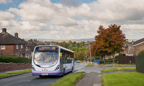 The number 24 bus drives up Spinkhill Avenue, overlooking the city of Sheffield in 2016.