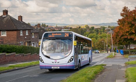 A local bus drives through a housing estate in Sheffield