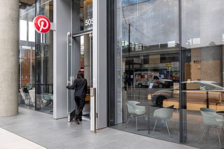 A person walking through a door with Pinterest’s logo at the top