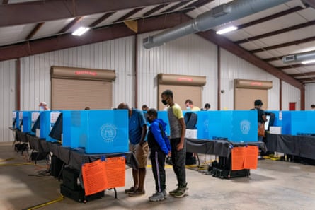 People cast their ballots at an early voting location at the Gwinnett county fairgrounds on 24 October in Lawrenceville, Georgia.
