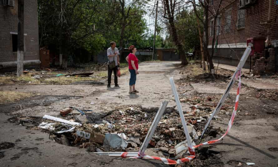 Residents outside damaged buildings.