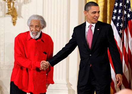 Barack Obama shaking hands with Sonny Rollins before presenting him with the 2010 National Medal of Arts during a ceremony at the White House.