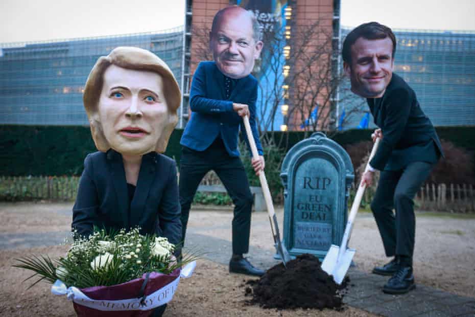 Protesters wearing masks of Ursula von der Leyen, Olaf Scholz and Emmanuel Macron gather around a mock Green Deal grave in Brussels, Belgium.