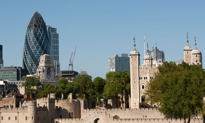 The Tower of London with the Gherkin building in the background in the city of London, England.