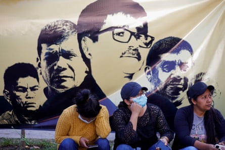 People rest as they attend a protest in support of five environmental activists accused of killing an alleged army informant more than 33 years ago, outside a courthouse during a hearing, in San Salvador, El Salvador, in January.