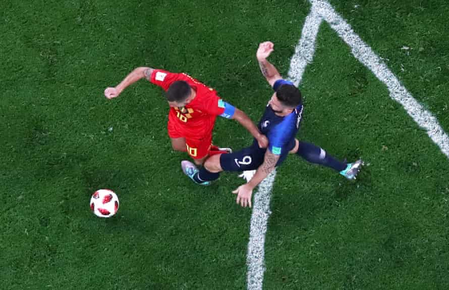 Belgium’s Eden Hazard hits the deck after the challenge of France’s Olivier Giroud.
