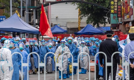 Staff members in protective suits transfer local residents at a community designated as high-risk for COVID-19 in Haizhu district on November 5, 2022 in Guangzhou, Guangdong Province of China.