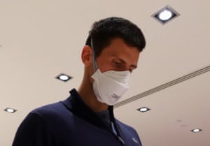 Novak Djokovic in Melbourne airport before boarding a flight on Sunday night.