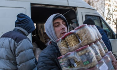 Food aid is delivered to refugees living in the basement of a school in Kharkiv, 15 March 2022.