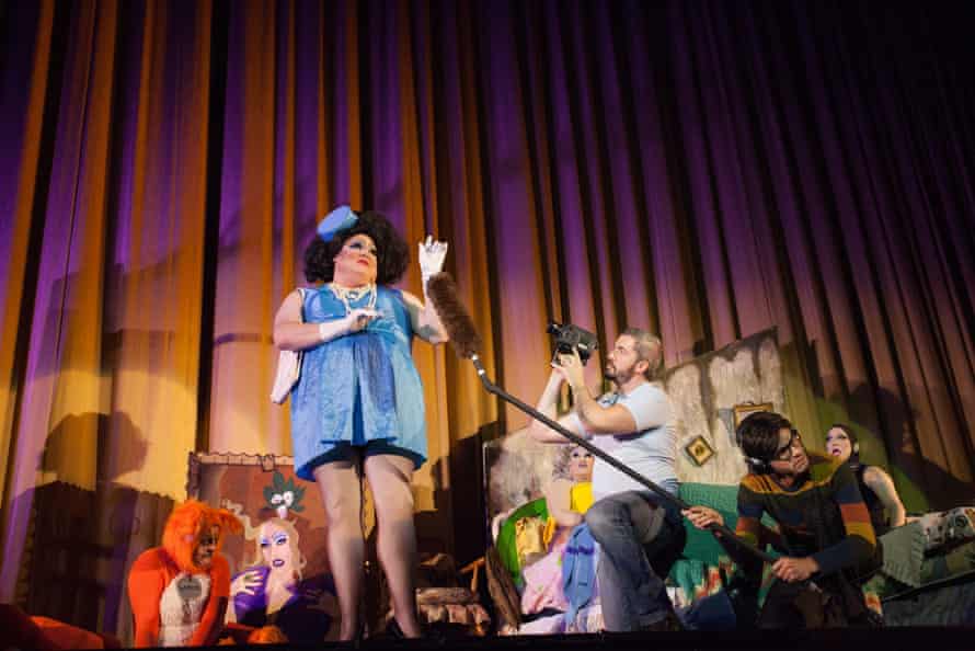 peaches performs in front of a person dressed as a cat or fox while someone holds a microphone in front of them