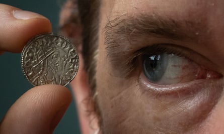 Ian Richardson, treasure registrar at the British Museum, holding a rare example of a mule coin