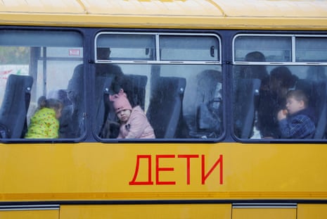 Children evacuated from Kherson wait in a bus heading to Crimea.
