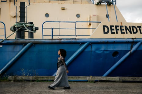 Girma walks past a docked ship