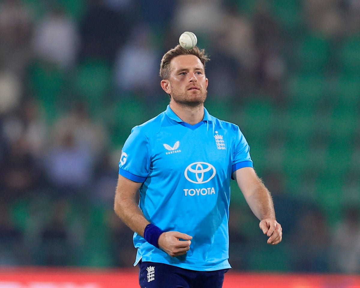 Liam Dawson, in England kit, throws a cricket ball into the air