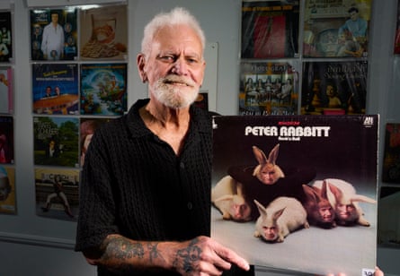 John Thompson, the former frontman of Peter Rabbitt, holding his album cover depicting his band emerging from rabbit bodies