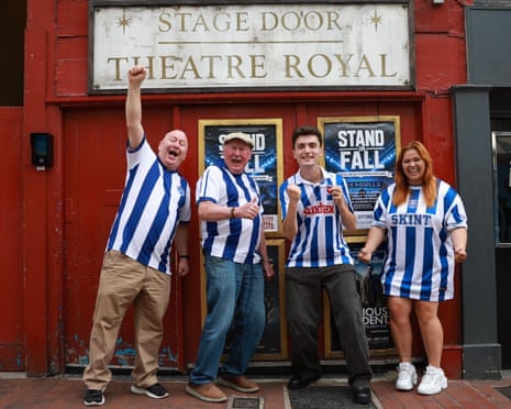 Cast of Stand or Fall, in Brighton shirts, cheer outside the Theatre Royal stage door