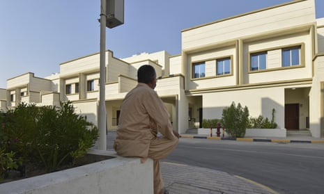 An Afghan man who was evacuated from Kabul sits on a wall at a temporary housing complex in Doha, Qatar.