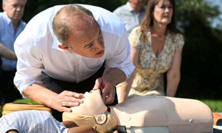 Ed Davey giving CPR to a plastic mannequin