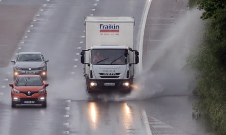 A lorry drives through a puddle on the M20 in Ashford, Kent