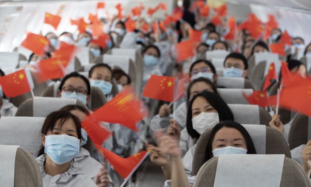Medical staff from Yunnan Province wave goodbye on the plane at Wuhan Tianhe International Airport