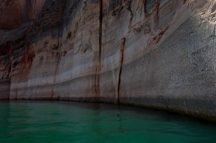 water lines on rocky shore of lake indicating low levels
