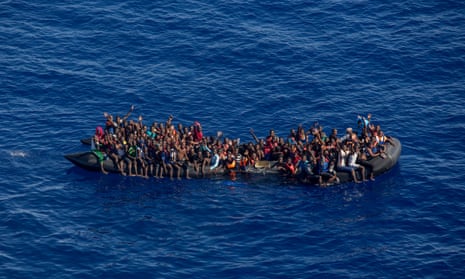A photo taken from the Moonbird plane  shows hundreds of migrants inside a rubber dinghy