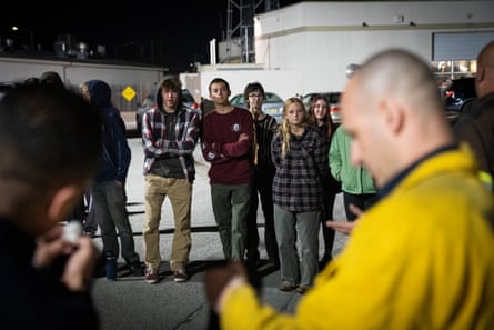 a group of people looking at a man