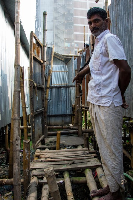 A hanging latrine at Abuller Bosti slum, Dhaka, Bangladesh. Like many other slum-dwellers, the residents can see the pile of human waste below their “toilet”.