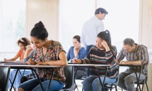 Students take a test in a classroom.