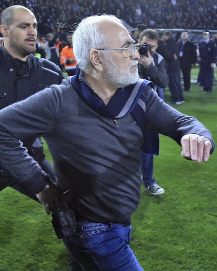 Ivan Savvidis enters the pitch for a second time, carrying what appears to be a pistol.