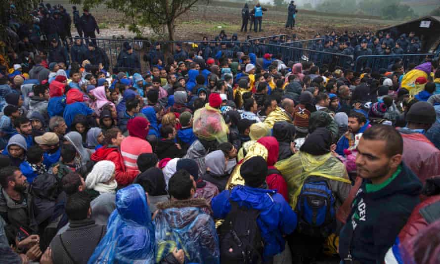 Migrants crowd as they wait to cross the Croatian border.