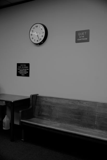 A courtroom bench underneath a clock. immersive-3-up
