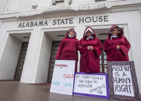 Women protest the anti-abortion bill in front of the Alabama State House on 17 April. Alabama recently passed a law making providing an abortion a felony.