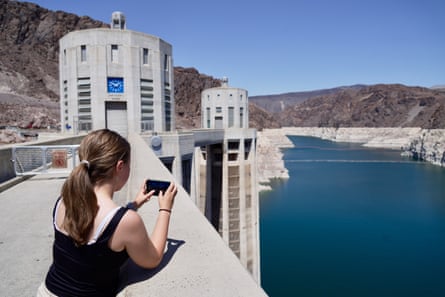 a woman points a cell phone to water