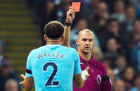 Manchester City’s Kyle Walker (L) is sent off by referee Robert Madley
