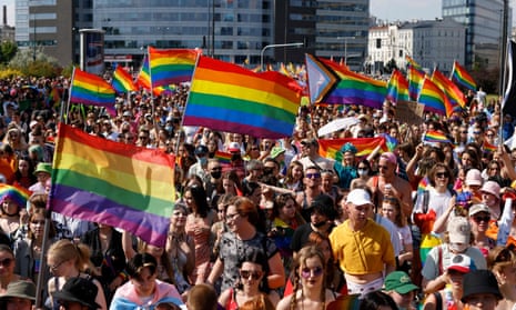 Marchers carry rainbow flags