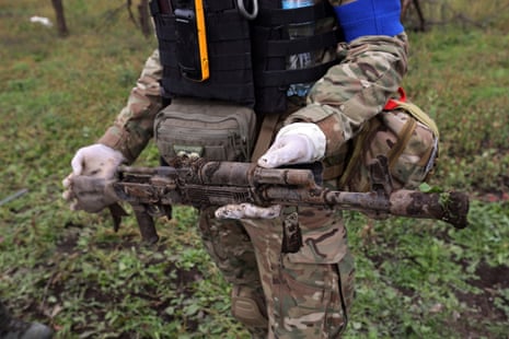 A rusted weapon covered in soil found during the exhumation of Ukrainian bodies in the village of Dementiivka, recently liberated from Russian occupation in the Kharkiv region.