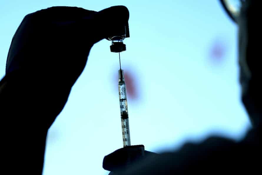 A dose of a Pfizer COVID-19 vaccine is prepared at a children’s hospital