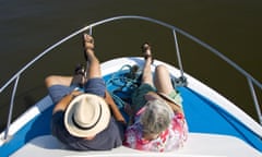An older man and a woman on the bow of a boat