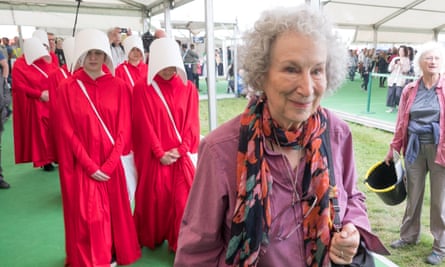 Ten handmaids escort Margaret Atwood around Britain's Hay literary festival in May.