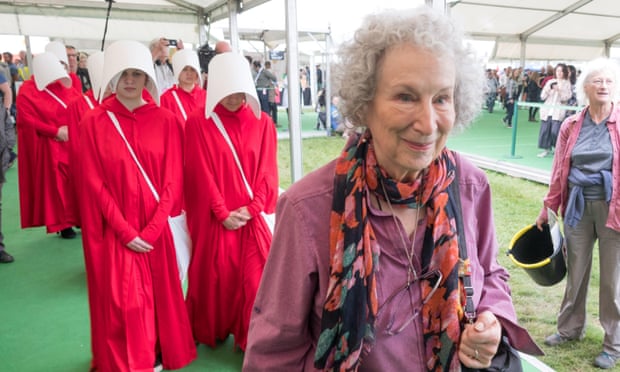 Ten handmaids escort Margaret Atwood around Britain’s Hay literary festival in May.