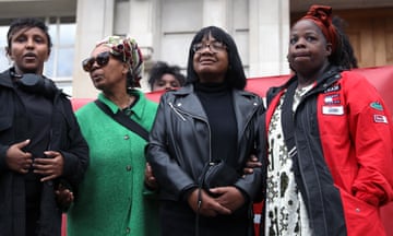 Diane Abbott standing with supporters on the steps of Hackney Town Hall.