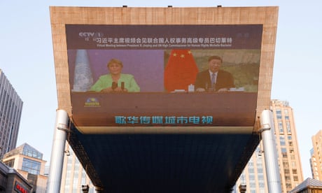 Virtual meeting between Chinese president, Xi Jinping, and UN high commissioner for human rights, Michelle Bachelet, broadcast on a giant screen in Beijing.