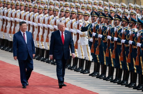 Donald Trump inspects an honour guard during a welcome ceremony with Xi Jinping.